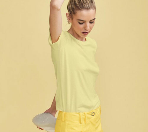 Woman wearing a Bella+Canvas tee in “pale yellow”.
