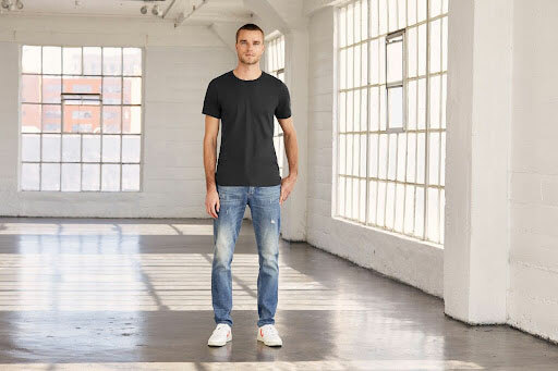 Man wearing the Bella+Canvas 3001C unisex ringspun cotton t-shirt in the color black.