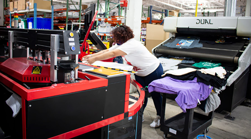 Woman working in a DTG print shop.