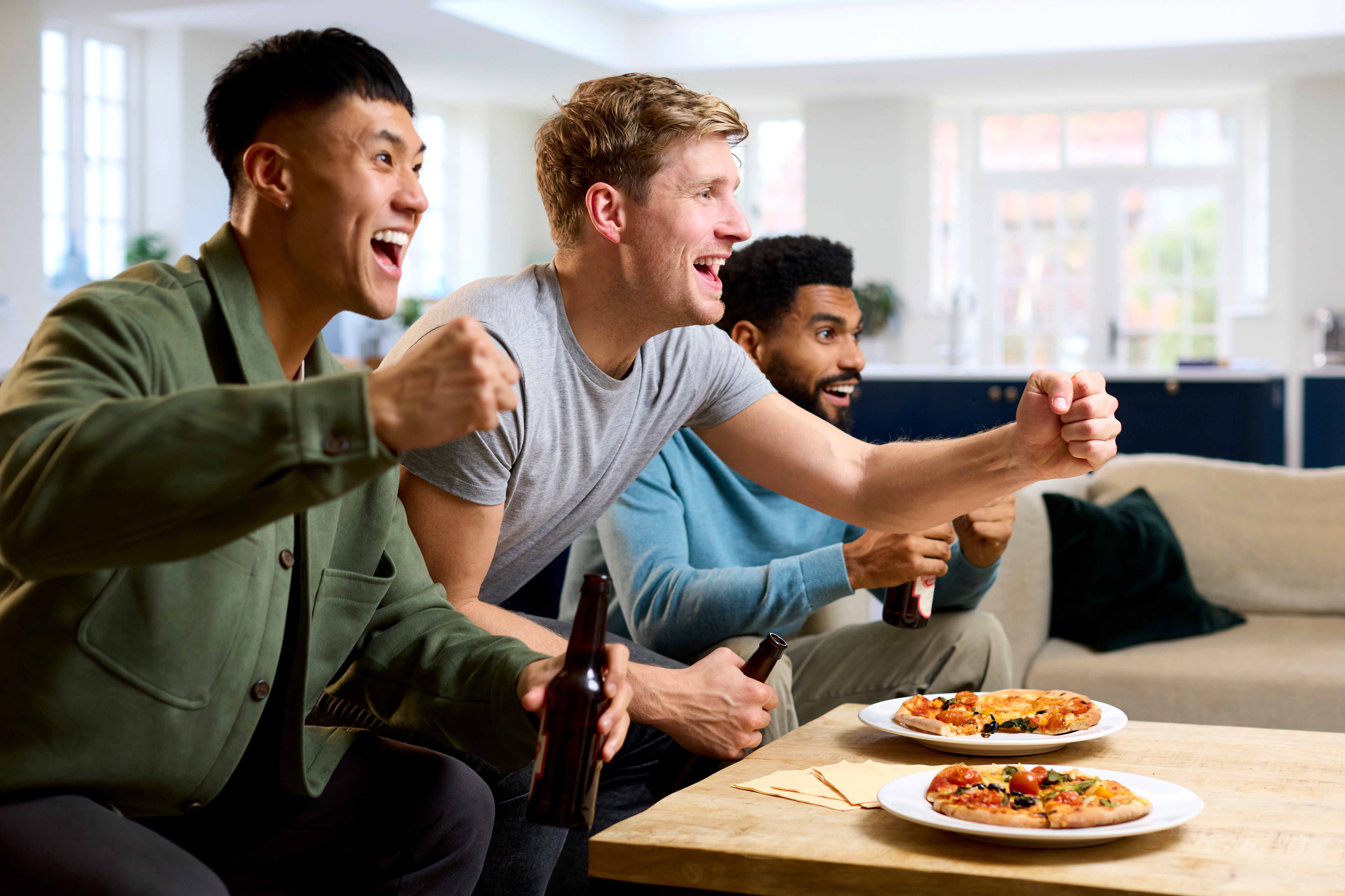 group-of-excited-male-friends-watching-sports-shirtspace.jpg