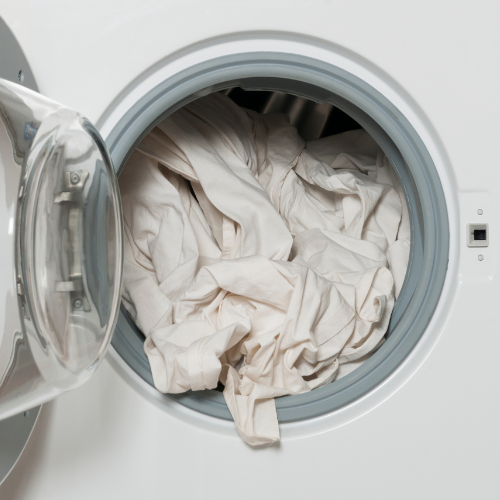 Laundry falling out of a washing machine