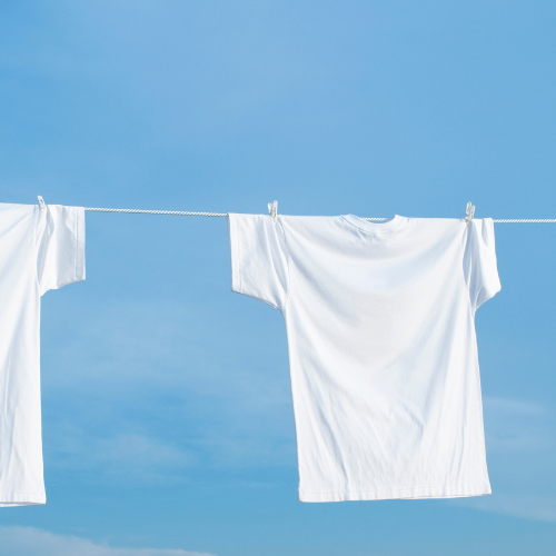 White shirts hang drying on a clothes line