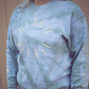 Woman wearing light blue teal faded tie dye crewneck sweatshirt made by ivy and olivia custom goods that reads beach please