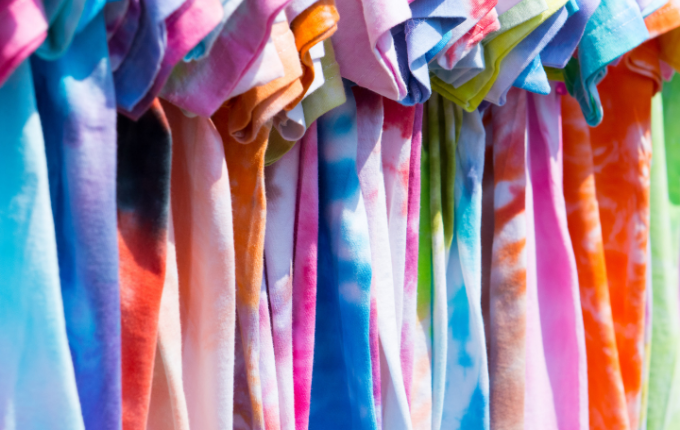 Colorful short-sleeve tie dye shirts hanging up 