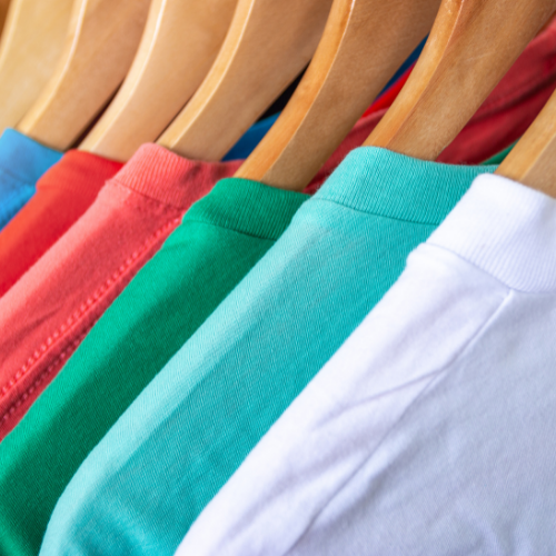 Colorful cotton shirts that look soft hanging on hangers.