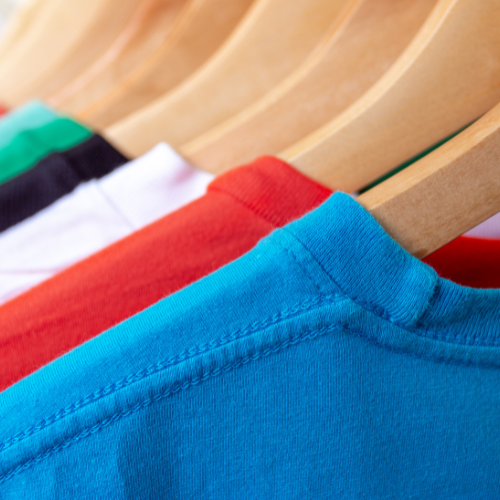 Cotton material t-shirts hanging by hangers