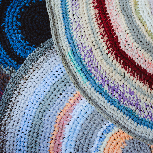 Colorful rugs made from fabric that were woven from old shirts