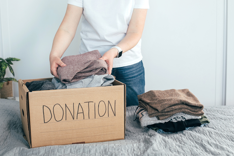 woman-donating-clothes-shirtspace.jpg
