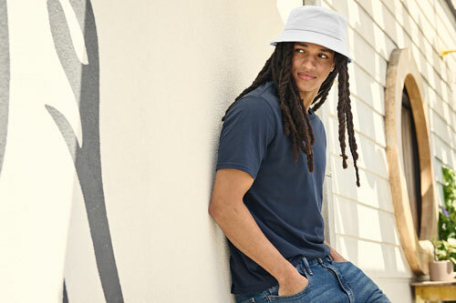 A man wearing a white Port Authority C975 Twill Classic Bucket Hat, available at ShirtSpace. 