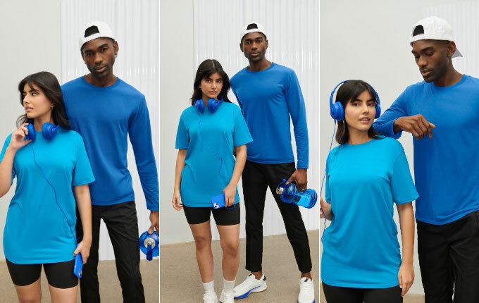 A man and woman at the gym in Gildan performance wear t-shirts from ShirtSpace.