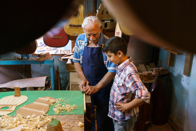grandpa-teaching-grandson-word-working-DIY-skills