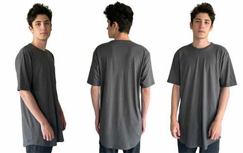 Man wearing an oversized tee, the Next Level 3602 Men's Cotton Long Body Crew in “heavy metal.”
