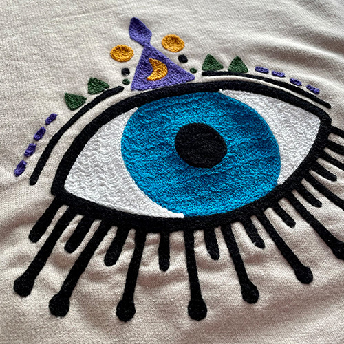 Embroidered eyeball on sweatshirt