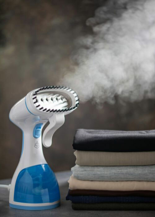 A hand held clothes steamer, used to steam wrinkles out of clothing, such as t-shirts.