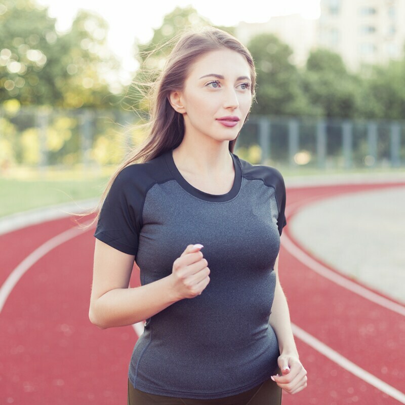 Woman running in a polyester shirt.