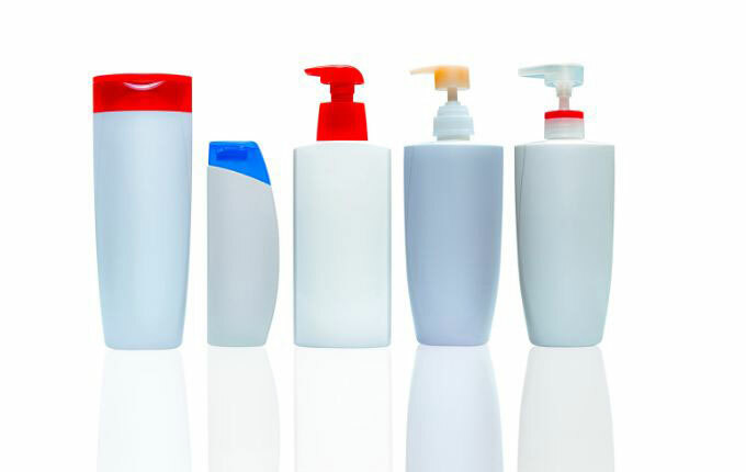 Five hair conditioner bottles without labels.