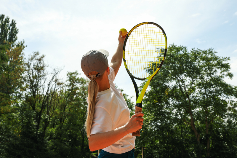 young-woman-in-white-t-shirt-serve-the-tennis-ball-shirtspace.jpg