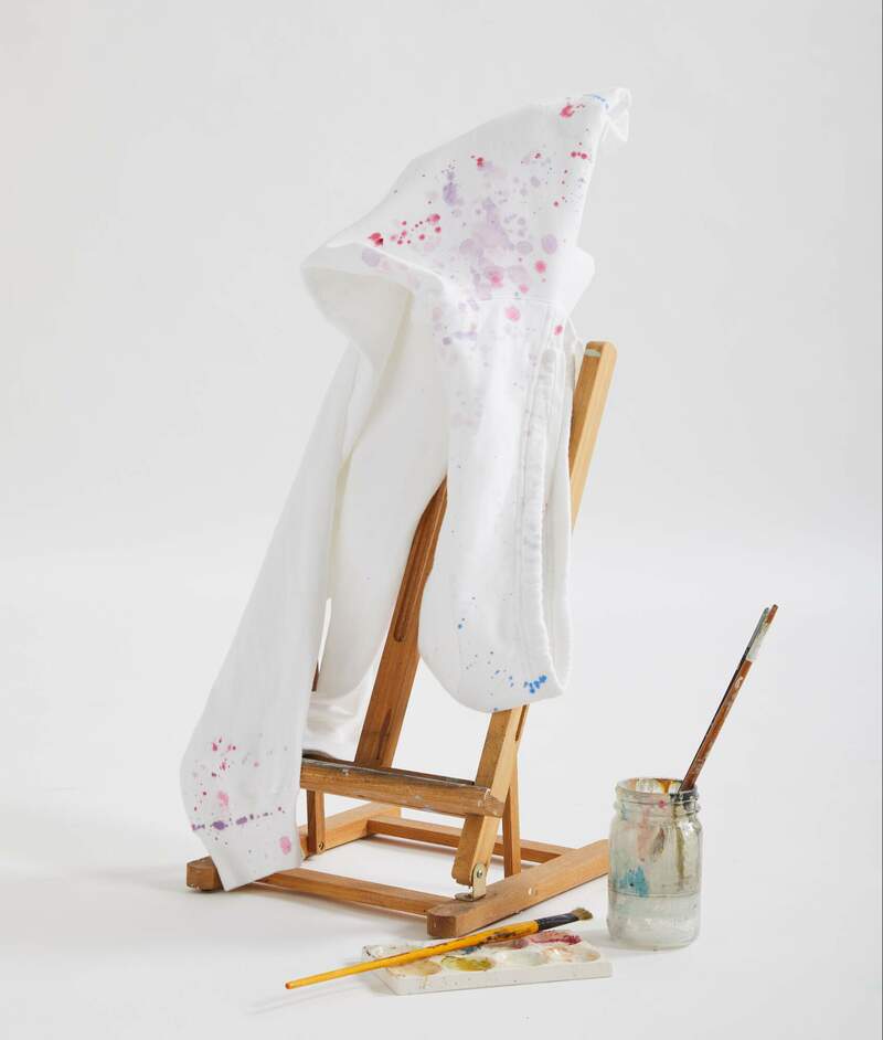 ComfortWash by Hanes GDH450 prepared for dye white hoodie hanging on an easel to be painted. 
