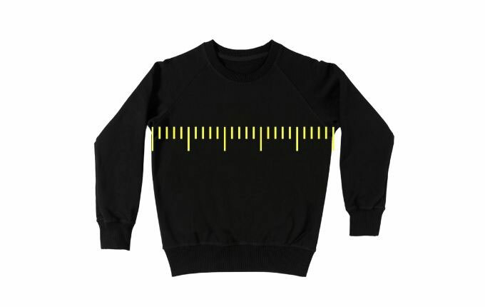 A black crewneck sweatshirt, with yellow ruler graphic to show how to measure for proper sweatshirt body width. 