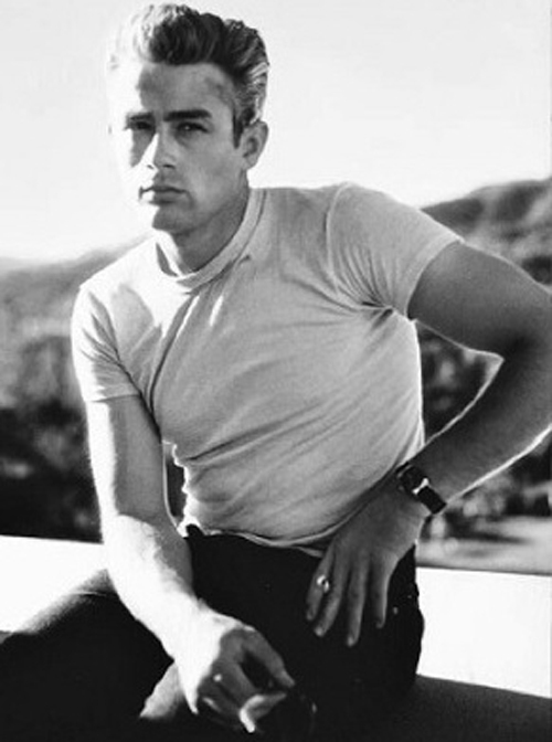 Black and white photo from 1955 of handsome movie star, James Dean, wearing a white t-shirt in the movie titled, Rebel WIthout a Cause.