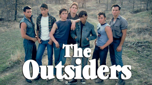 Promotional movie photo with the main cast of the film, The Outsiders, that helped catapult white t-shirts into popular culture. 