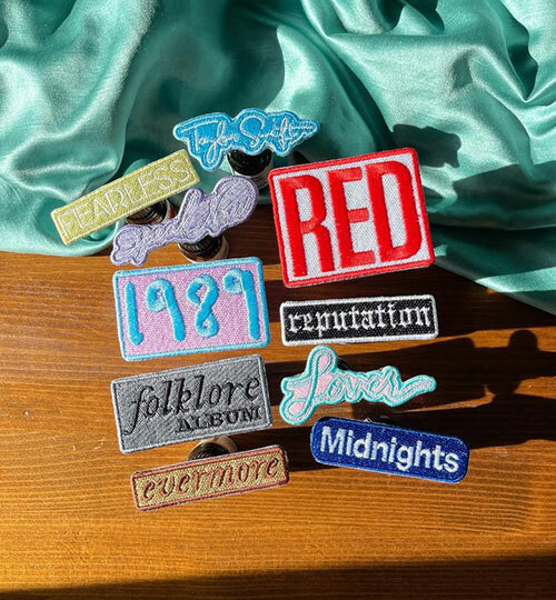Taylor Swift embroidered patches representing her different “Eras,” or albums, by Carissa by the Sea.