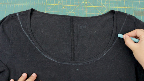 black shirt marked with chalk where it must be cut to be an off the shoulder shirt