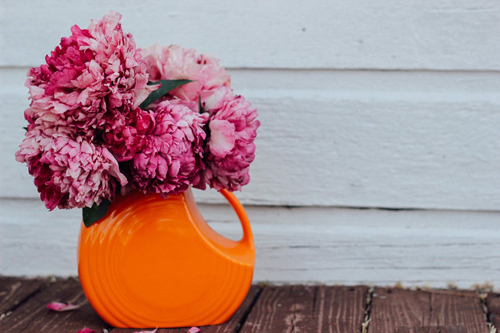Pink flowers in a orange vase