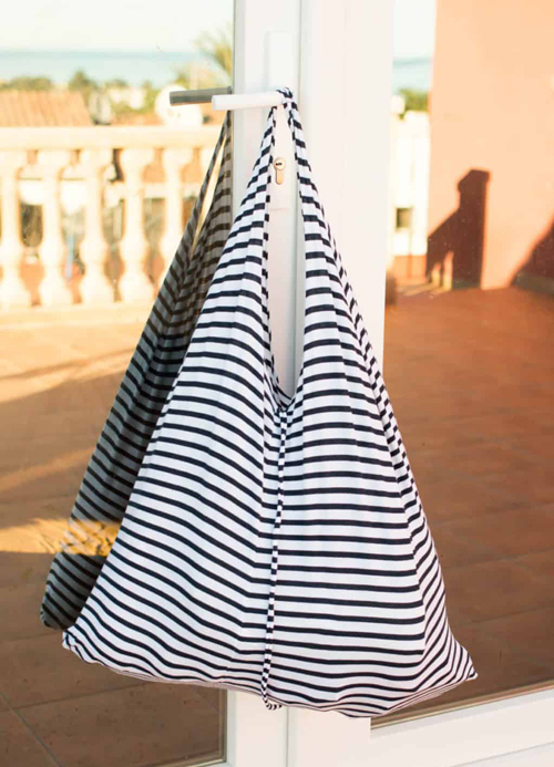 Black and white striped tote bag made from a t-shirt hanging from door handle