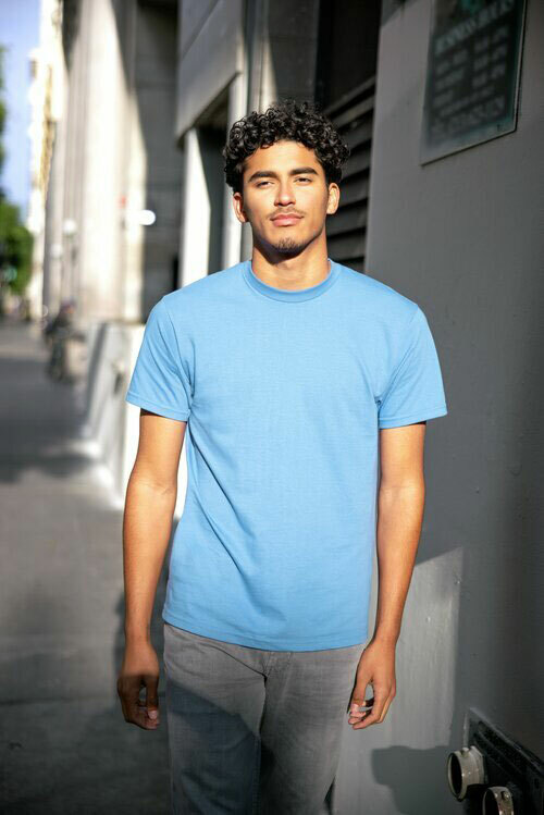Man modeling the Anvil by Gildan 980 unisex tee in the color light blue. 