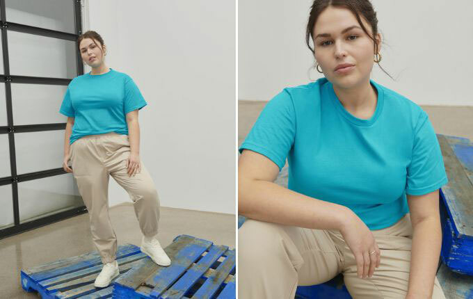Woman wearing the Gildan H000 Hammer T-Shirt in “lagoon blue” while standing on blue painted palettes.