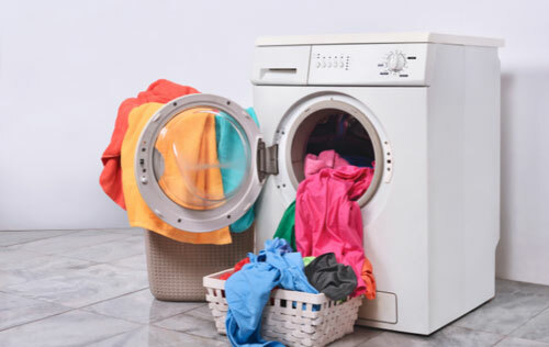 Wash machine with colorful t-shirts.