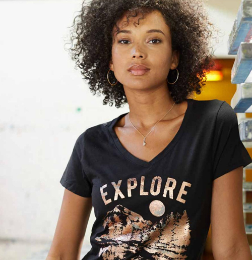 Woman wearing black shirt that says "explore"