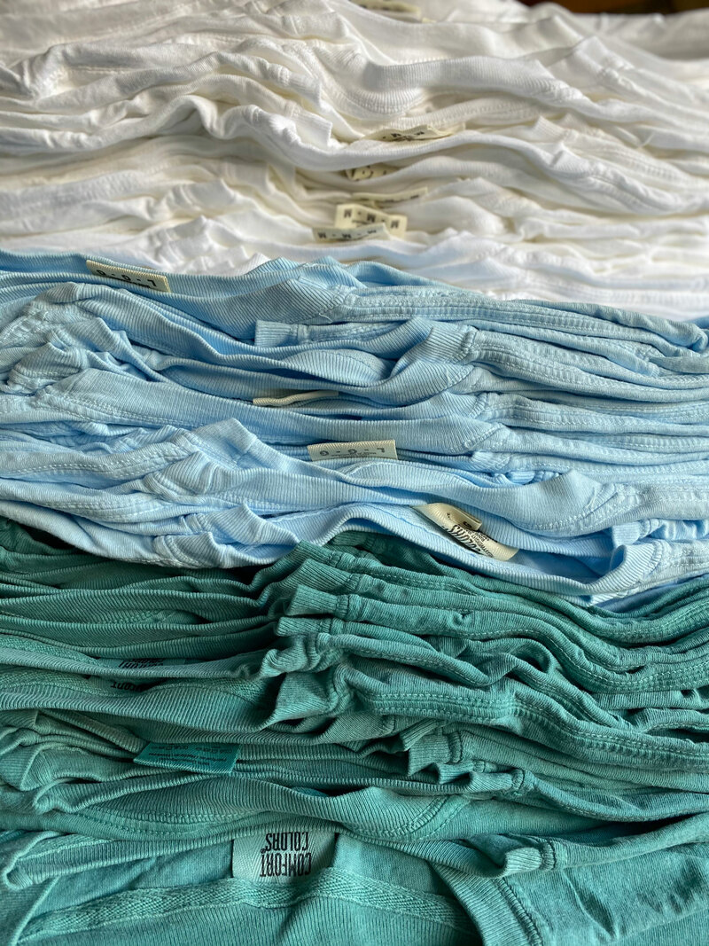 Comfort Colors C1717 Heavyweight Ringspun Tees from ShirtSpace in the colors “Seafoam”, “Chambray” and “White”, stacked up. 