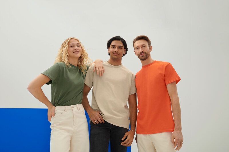 Woman and two men wearing the Gildan G200 Ultra Cotton T-Shirt in “Military Green”, “Natural” and “Orange” from ShirtSpace.