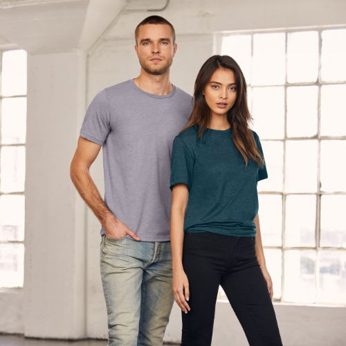Man with grey shirt standing next to woman with dark teal t-shirt