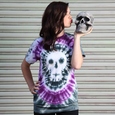 A woman wearing a white t-shirt, tie-dyed with a black, gray and purple skull design. 